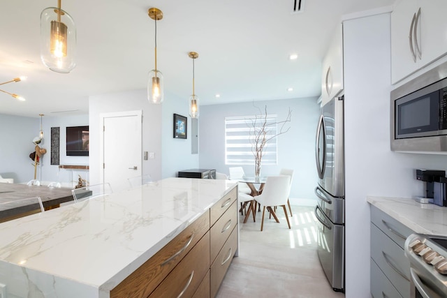 94825 Overseas Hwy Unit 204, Key Largo, FL 33037 - kitchen with stainless steel appliances, light stone countertops, hanging light fixtures, and recessed lighting