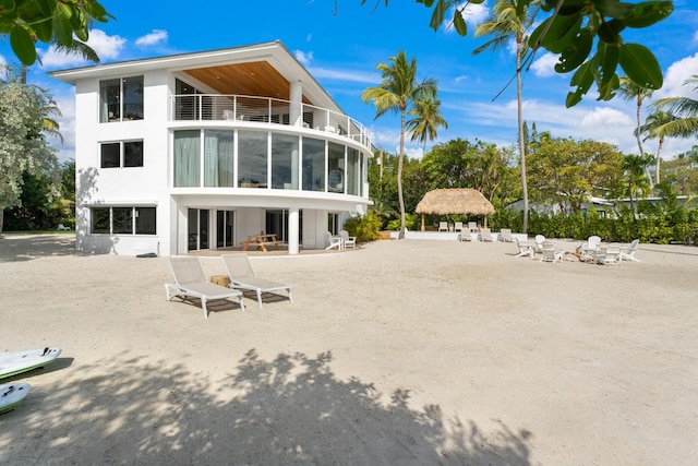 rear view of property with a balcony and a patio