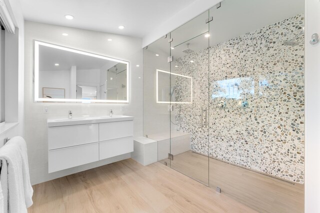 bathroom with vanity, hardwood / wood-style floors, and walk in shower