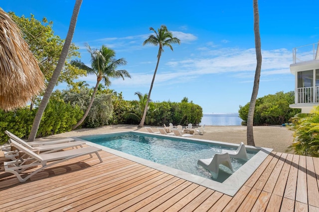 view of pool with a deck with water view