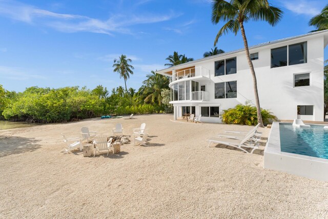 back of house with a balcony and a patio