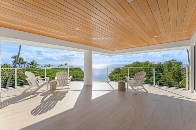 view of patio / terrace featuring a balcony and a water view