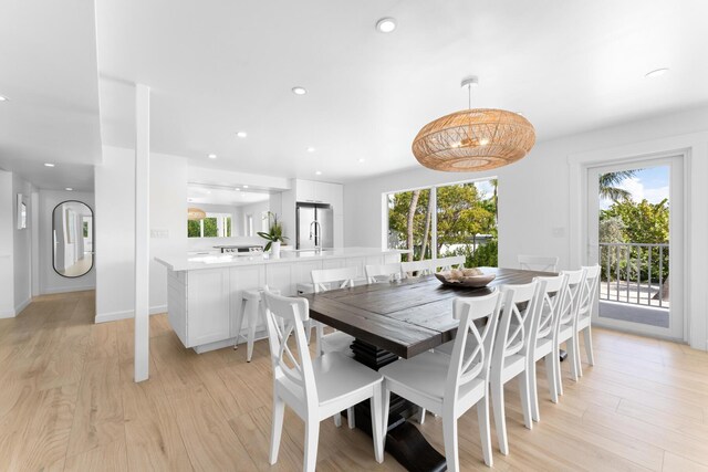 dining room featuring plenty of natural light and light hardwood / wood-style flooring