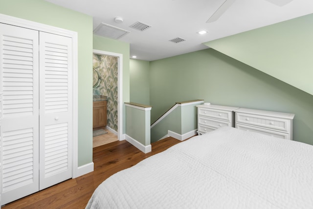 bedroom with a closet, visible vents, wood finished floors, and recessed lighting