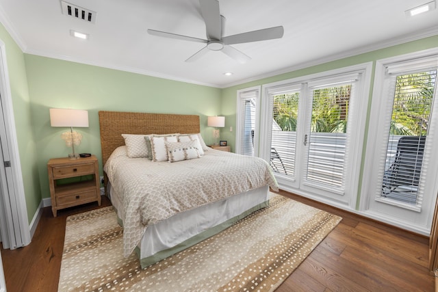 bedroom with baseboards, visible vents, wood finished floors, access to outside, and crown molding