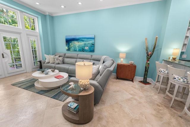 living area with baseboards, recessed lighting, and crown molding