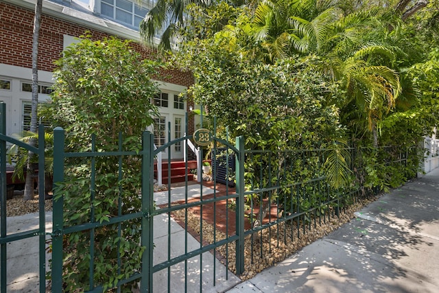 view of gate with a fenced front yard