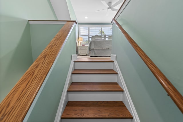 staircase featuring ceiling fan