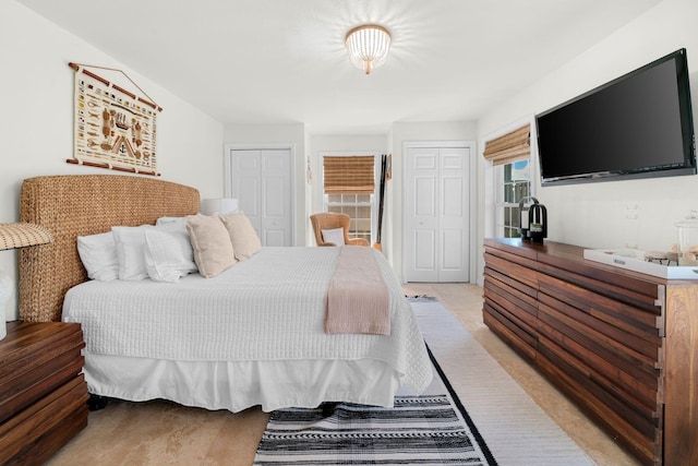 carpeted bedroom featuring two closets