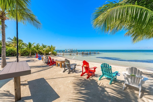 exterior space featuring a water view and a beach view