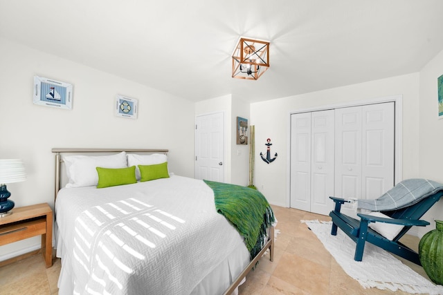 bedroom with light tile patterned flooring and a closet