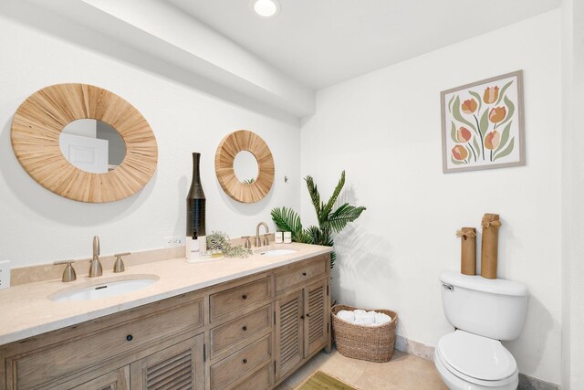 bathroom featuring tile patterned floors, vanity, and toilet