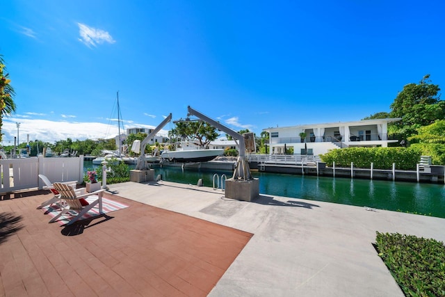 view of patio with a water view and a dock