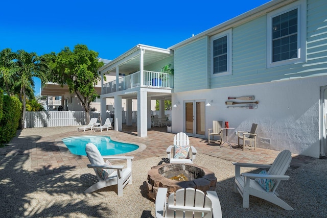 view of swimming pool with a patio and an outdoor fire pit