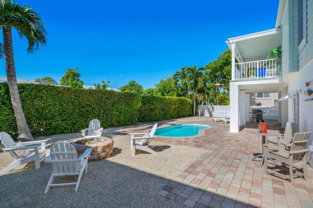 view of pool with a patio area and an outdoor fire pit