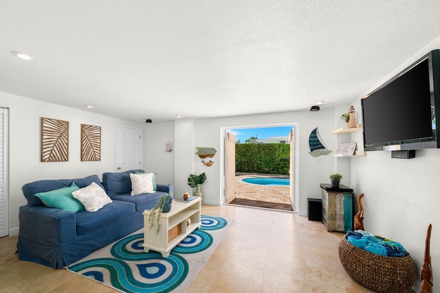 living room featuring light tile patterned floors and a textured ceiling