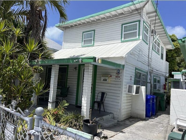 720-726 Emma St, Key West, FL 33040 - view of front facade featuring covered porch and a metal roof