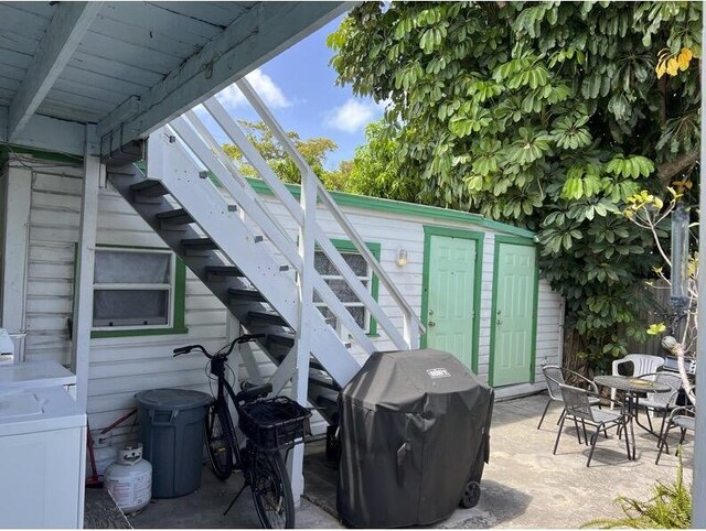 720-726 Emma St, Key West, FL 33040 - view of patio / terrace with stairway, a grill, washer / dryer, a storage shed, and outdoor dining area