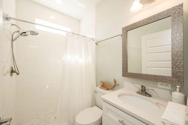 bathroom with vanity, a shower with curtain, and toilet