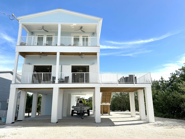 back of property featuring ceiling fan and a carport