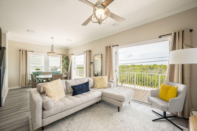 living room featuring crown molding, wood-type flooring, and ceiling fan