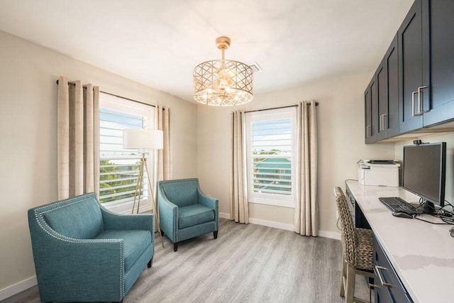 office featuring a notable chandelier and light hardwood / wood-style flooring