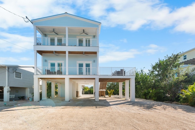 back of property with a carport, ceiling fan, and french doors