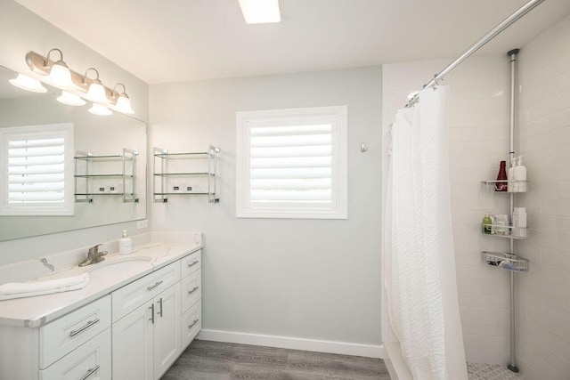 bathroom with a shower with curtain, vanity, and hardwood / wood-style flooring