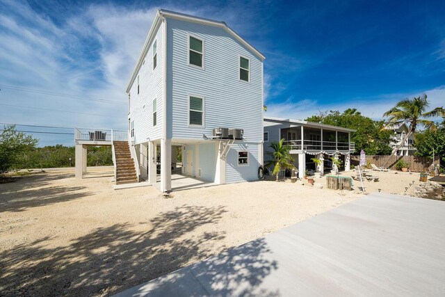 back of property featuring a sunroom, a patio, and central air condition unit