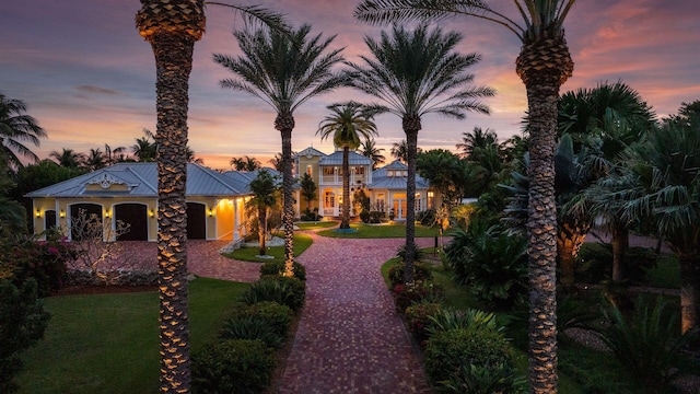 mediterranean / spanish home featuring a yard