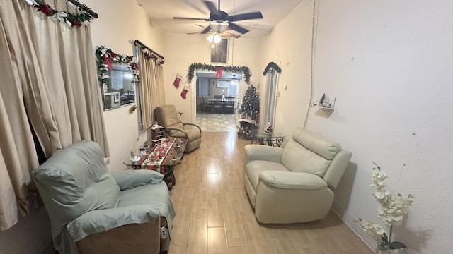 living room with ceiling fan and light hardwood / wood-style flooring