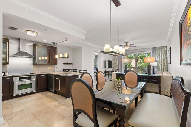 dining area with ceiling fan, visible vents, and crown molding