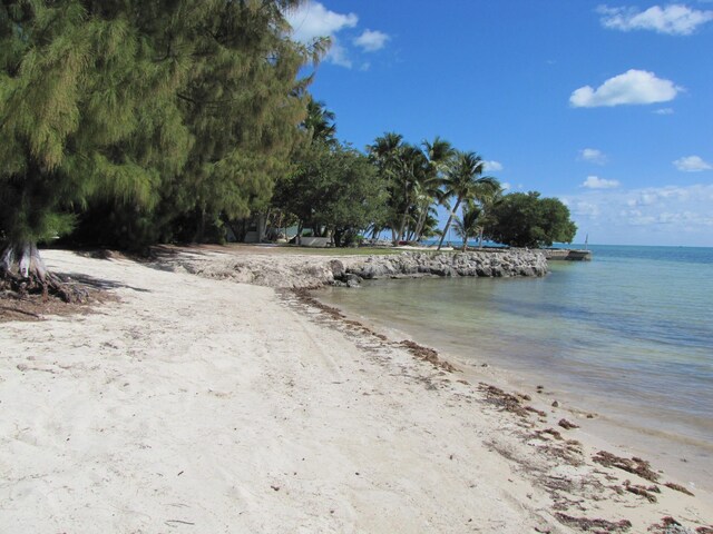 surrounding community featuring a water view and a view of the beach