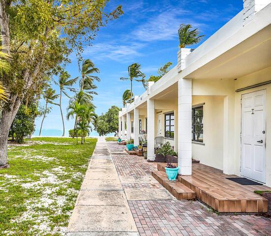 view of yard featuring a water view and a beach view