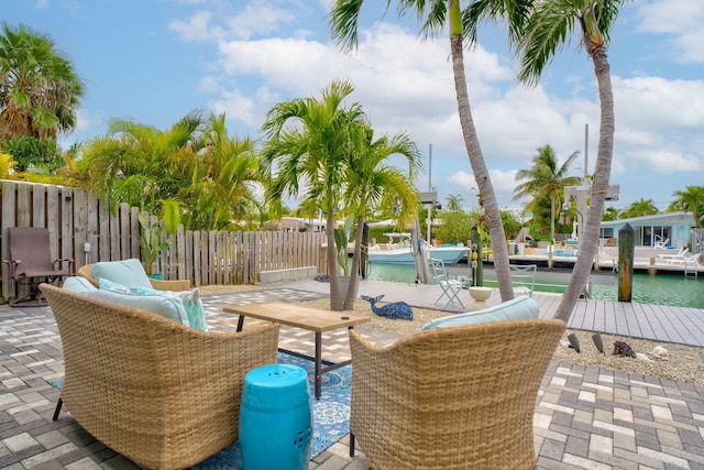 view of patio featuring a dock and fence