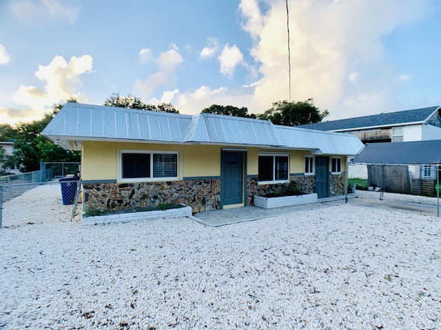 577 Boyd Dr, Key Largo, FL 33037 - view of front of house with stone siding, stucco siding, and metal roof