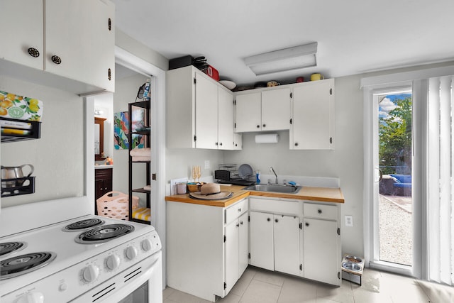 577 Boyd Dr, Key Largo, FL 33037 - kitchen featuring a sink, white electric stove, light countertops, light tile patterned flooring, and white cabinetry