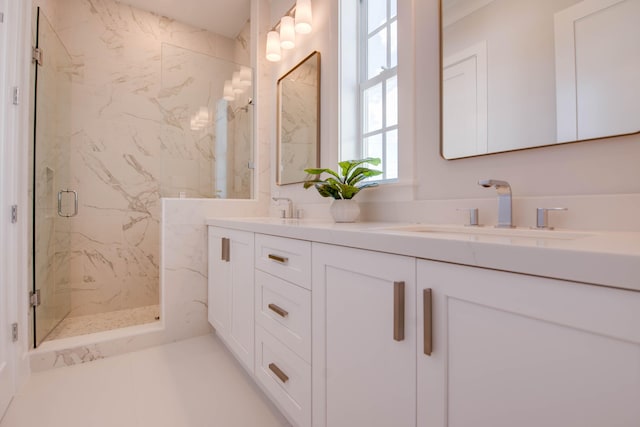 bathroom with vanity and a shower with door