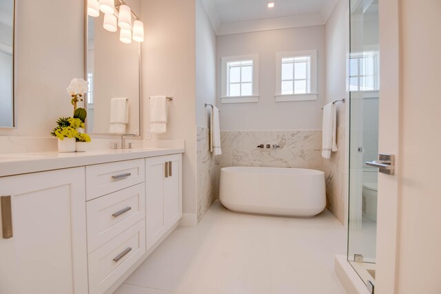 bathroom featuring toilet, tile walls, ornamental molding, vanity, and a tub