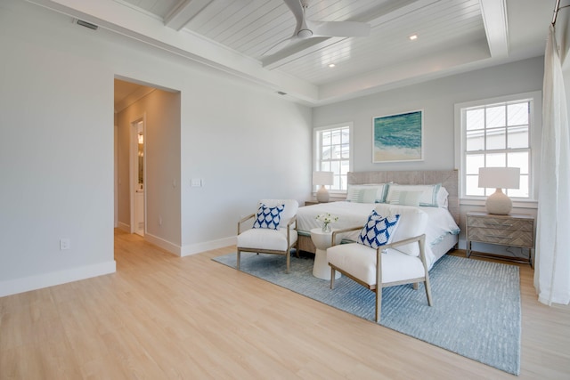 bedroom with wood ceiling, light hardwood / wood-style floors, a raised ceiling, and beamed ceiling