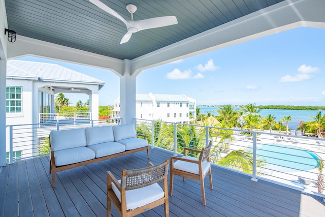 wooden terrace featuring an outdoor living space, a water view, and ceiling fan