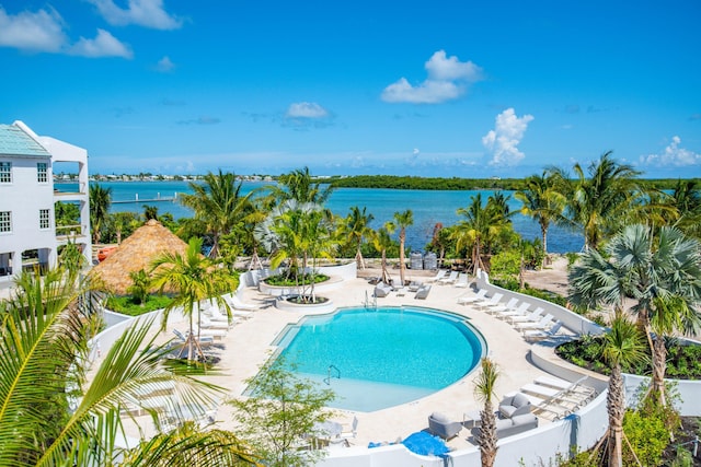 view of pool with a water view and a patio area