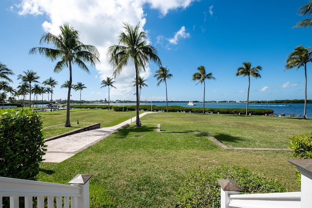 view of community featuring a water view and a lawn