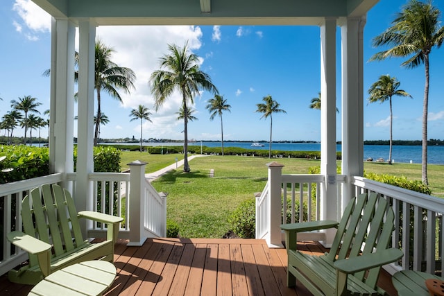 wooden terrace featuring a yard and a water view