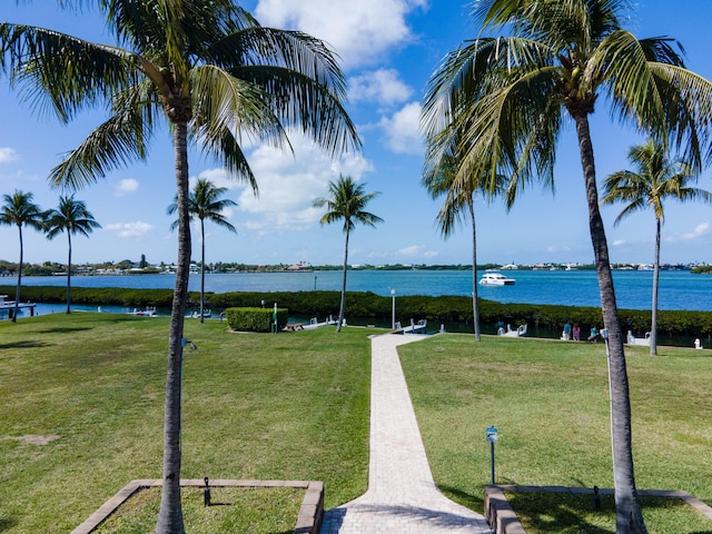 view of community with a yard and a water view