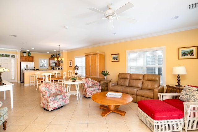 living room featuring ceiling fan, ornamental molding, and light tile patterned floors