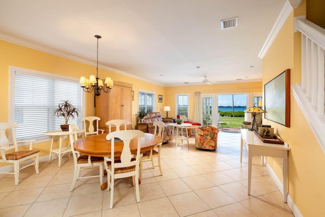 tiled dining room with crown molding and ceiling fan with notable chandelier