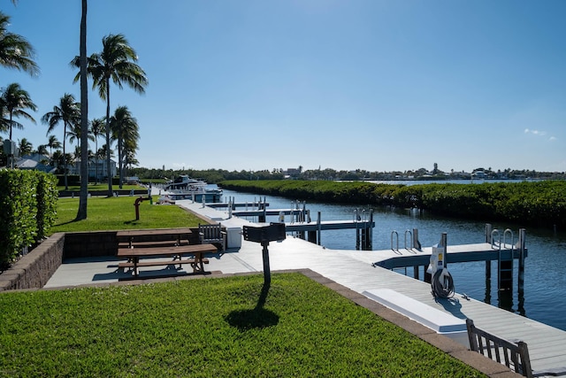 dock area with a water view and a lawn