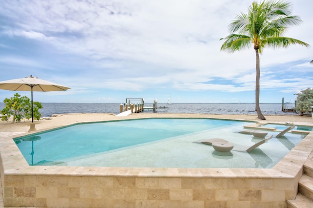 view of pool with an in ground hot tub and a water view