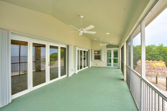 unfurnished sunroom featuring french doors, a ceiling fan, and vaulted ceiling